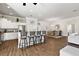 Bright kitchen boasts white cabinets, granite counters, and breakfast bar at 17257 Se 113Th Ave, Summerfield, FL 34491