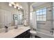Clean bathroom with shower/tub combo, updated vanity, and tile flooring at 17257 Se 113Th Ave, Summerfield, FL 34491