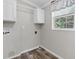 Laundry room with upper cabinets and wood-look floors at 18451 14Th Ave, Orlando, FL 32833