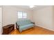 Bedroom with wood floors, futon, and window shutters at 1233 Overlook Rd, Eustis, FL 32726