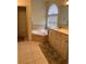 Spa-like bathroom with a soaking tub and updated vanity at 16232 Arrowhead Trl, Clermont, FL 34711