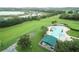 Community pool with a green patio cover and surrounding grass at 4088 Kingsley St, Clermont, FL 34711
