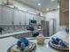 Modern kitchen with gray cabinets and quartz countertops; stainless steel appliances at 6152 Topsail Rd, Lady Lake, FL 32159