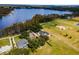 Aerial view showcasing a house with a pool, nestled on a spacious lot near a lake at 9832 Florida Boys Ranch Rd, Clermont, FL 34711