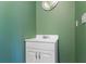 Small bathroom with a white vanity and green walls at 9832 Florida Boys Ranch Rd, Clermont, FL 34711