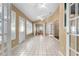 Spacious sunroom featuring tile flooring and multiple windows at 3064 Windham Dr, Eustis, FL 32726