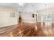 Open concept living room and dining area with hardwood floors and a fireplace at 3064 Windham Dr, Eustis, FL 32726