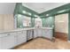 White kitchen with stainless steel appliances and tile flooring at 3064 Windham Dr, Eustis, FL 32726