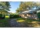 Backyard with grassy area and a white arbor at 3064 Windham Dr, Eustis, FL 32726