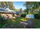 Backyard view showing a large tree and grassy area at 3064 Windham Dr, Eustis, FL 32726