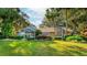 Single-story home with manicured lawn and palm trees at 3064 Windham Dr, Eustis, FL 32726