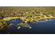 Aerial view of waterfront homes with private docks and lush landscaping at 3064 Windham Dr, Eustis, FL 32726