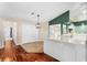 Kitchen and dining area with hardwood floors and green accent wall at 3064 Windham Dr, Eustis, FL 32726