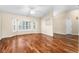 Bright and airy living room with hardwood floors, large windows, and ceiling fan at 3064 Windham Dr, Eustis, FL 32726