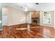 Spacious living room featuring hardwood floors, a brick fireplace, and vaulted ceilings at 3064 Windham Dr, Eustis, FL 32726