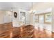 Formal dining area with hardwood floors, a chandelier, and views to the kitchen at 3064 Windham Dr, Eustis, FL 32726