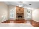 Living room with hardwood floors and a brick fireplace at 3064 Windham Dr, Eustis, FL 32726