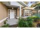 Inviting home exterior featuring a covered entryway, well-manicured landscaping, and updated windows at 3064 Windham Dr, Eustis, FL 32726