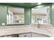 Kitchen features a corner sink, stainless steel appliances, and pass-through window at 3064 Windham Dr, Eustis, FL 32726