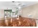 Open living area with hardwood floors, kitchen island, and a view into the dining area at 3064 Windham Dr, Eustis, FL 32726