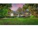 Single-story home with lush landscaping at dusk at 3064 Windham Dr, Eustis, FL 32726