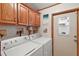 Laundry room with washer, dryer, and ample cabinet space at 25504 Belle Alliance, Leesburg, FL 34748