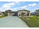 Front view of the house with a driveway and garage at 25504 Belle Alliance, Leesburg, FL 34748