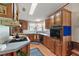 This kitchen features wood cabinets, a built-in oven, and a corner sink at 25504 Belle Alliance, Leesburg, FL 34748