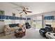 Living room features a sofa, two chairs, a coffee table, and sliding doors leading to a lake view at 25504 Belle Alliance, Leesburg, FL 34748