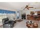 Bright living room with comfy seating, a view into the kitchen, and a ceiling fan at 25504 Belle Alliance, Leesburg, FL 34748