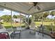 Screened porch with seating area and ceiling fan at 25504 Belle Alliance, Leesburg, FL 34748