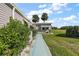 Mobile home exterior features a walkway and landscaping at 25504 Belle Alliance, Leesburg, FL 34748