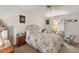 Bedroom with floral bedding, nightstand, and rocking chair at 25504 Belle Alliance, Leesburg, FL 34748