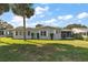 Exterior view of a single-story home with a large yard at 25504 Belle Alliance, Leesburg, FL 34748