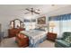 Main bedroom with a comfortable bed, dresser, and ceiling fan at 25504 Belle Alliance, Leesburg, FL 34748