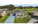 Aerial view of a mobile home with a driveway and green space at 25504 Belle Alliance, Leesburg, FL 34748