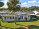 Mobile home exterior showcasing a side view and landscaping at 25504 Belle Alliance, Leesburg, FL 34748