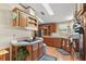 Well-equipped kitchen with wood cabinets, corner sink, and a breakfast bar at 25504 Belle Alliance, Leesburg, FL 34748