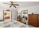 Spacious main bedroom with dresser, TV stand, and access to bathroom at 25504 Belle Alliance, Leesburg, FL 34748