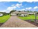 A charming house with a brick driveway and manicured landscaping at 5096 Greens Dr, Lady Lake, FL 32159