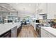 Bright kitchen with white cabinets and stainless steel appliances at 5096 Greens Dr, Lady Lake, FL 32159