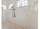 Large walk-in shower with double shower heads and built-in bench at 5096 Greens Dr, Lady Lake, FL 32159