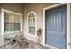 Inviting front entry with a bench and gray door at 5096 Greens Dr, Lady Lake, FL 32159