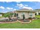 Landscaped yard with curved retaining wall and decorative plants at 5096 Greens Dr, Lady Lake, FL 32159