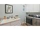 Laundry room with washer, dryer, utility sink, and built-in cabinets at 5096 Greens Dr, Lady Lake, FL 32159