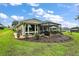 Landscaped backyard with a covered patio and beautiful lawn at 5096 Greens Dr, Lady Lake, FL 32159