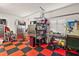 Garage with stainless steel cabinets, work bench, and checkered floor at 5096 Greens Dr, Lady Lake, FL 32159
