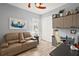 Home office with a couch, work desk, and built-in cabinets at 5096 Greens Dr, Lady Lake, FL 32159