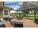 Relaxing covered patio with seating area, overlooking a tranquil golf course view at 5096 Greens Dr, Lady Lake, FL 32159