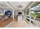 Sunroom features a built-in bar, comfortable seating, and views of the backyard at 5096 Greens Dr, Lady Lake, FL 32159